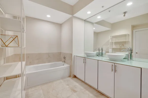 a bathroom with a sink toilet a mirror and shower