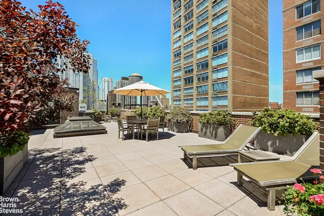 a living room with furniture and a lamp