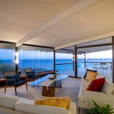a living room with furniture and a floor to ceiling window