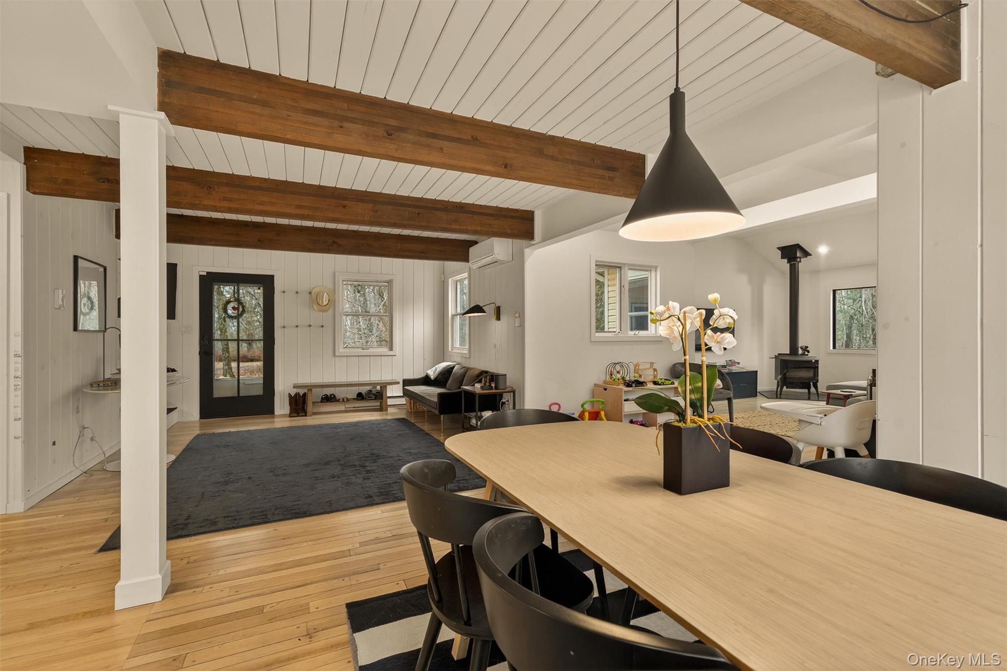351 Gables Road Narrowsburg, NY 12764 - Photo 16 of 49 a view of a dining room and livingroom with furniture wooden floor windows