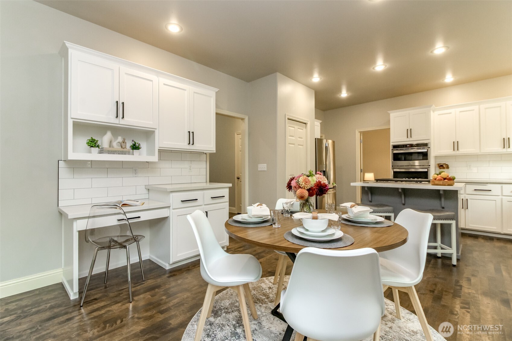 1913 Northeast 32nd Street Renton, WA 98056 - Photo 12 of 40 a kitchen with stainless steel appliances kitchen island granite countertop a kitchen island a stove a table and chairs