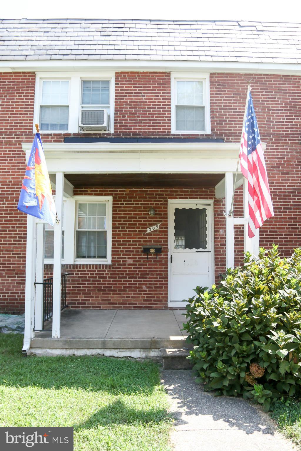 309 Westowne Road Baltimore, MD 21229 - Photo 1 of 20 a front view of a house with garden