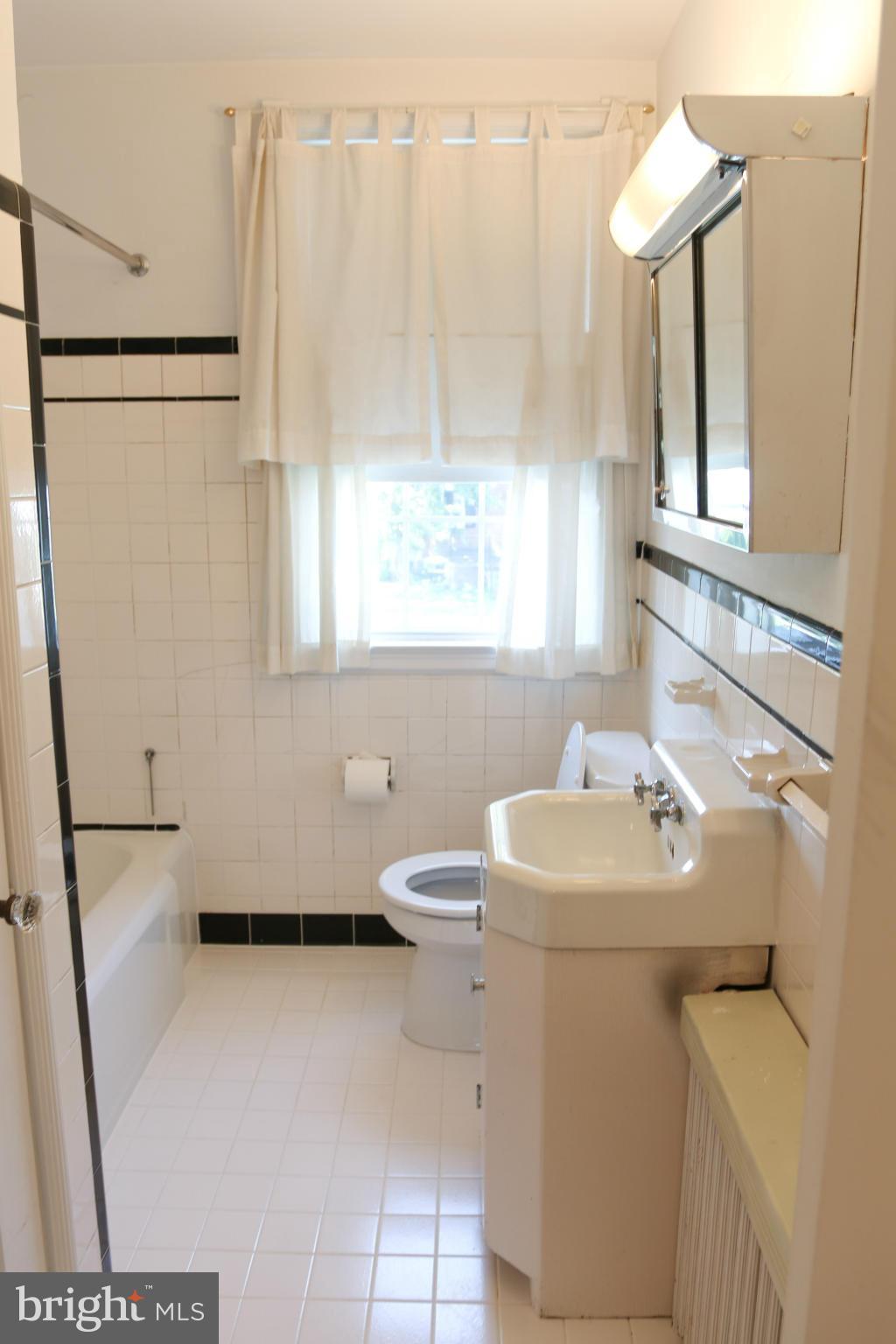 309 Westowne Road Baltimore, MD 21229 - Photo 14 of 20 a bathroom with a sink toilet and window