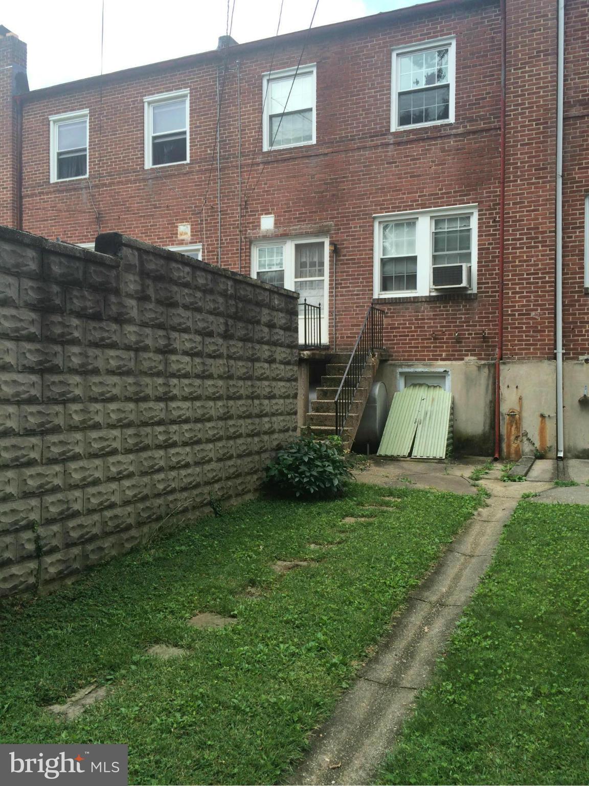 309 Westowne Road Baltimore, MD 21229 - Photo 17 of 20 a view of a brick house with a yard