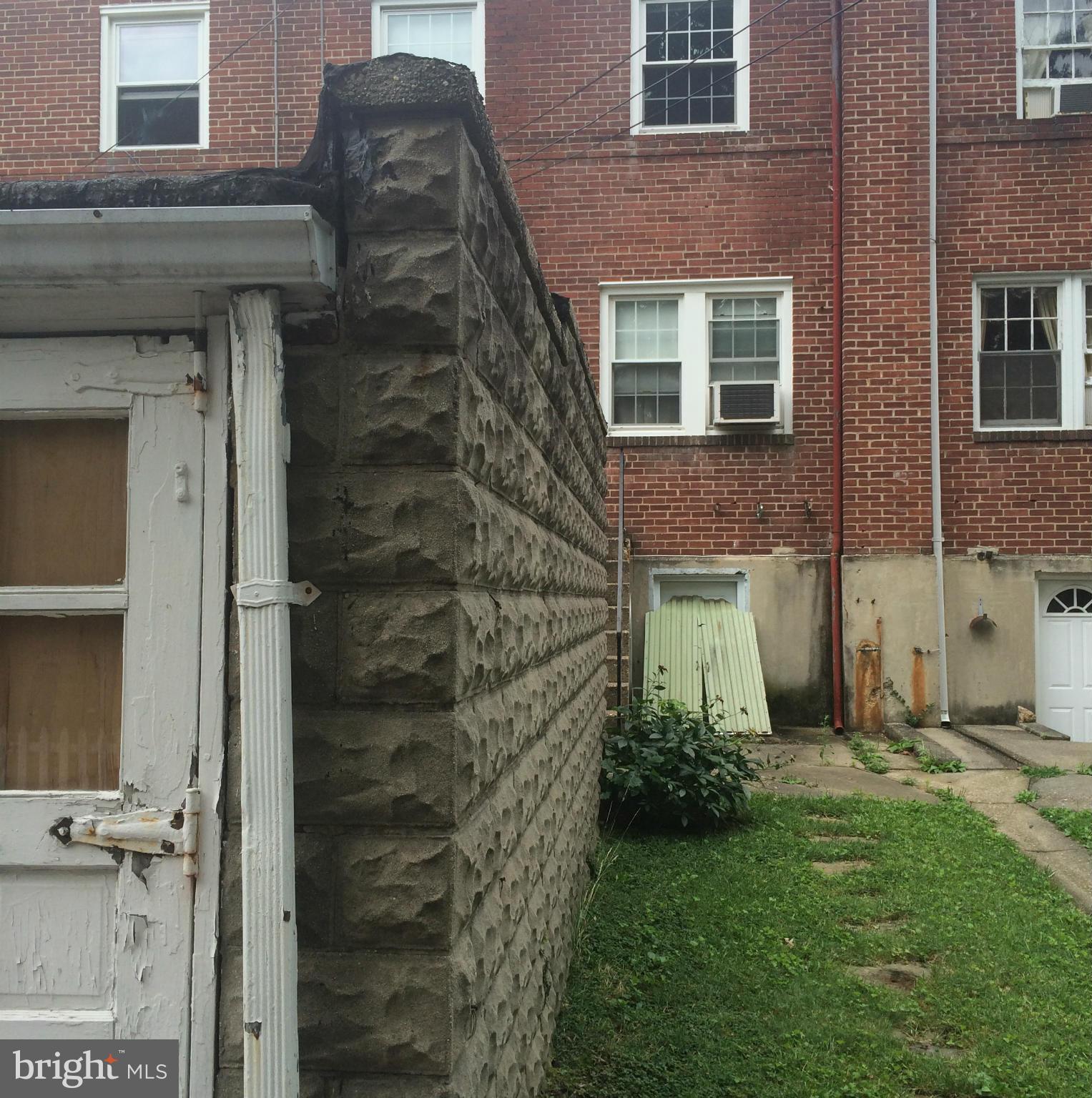 309 Westowne Road Baltimore, MD 21229 - Photo 19 of 20 a brick building with a bench in front of it