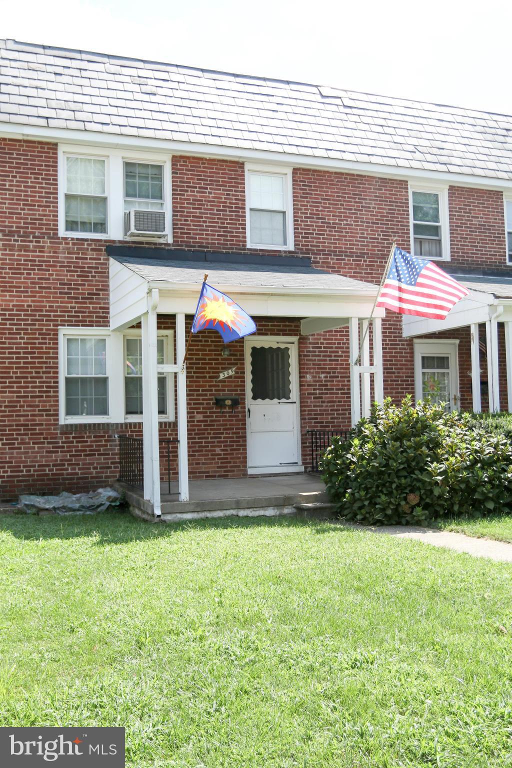 309 Westowne Road Baltimore, MD 21229 - Photo 20 of 20 a view of a brick house with a yard and plants