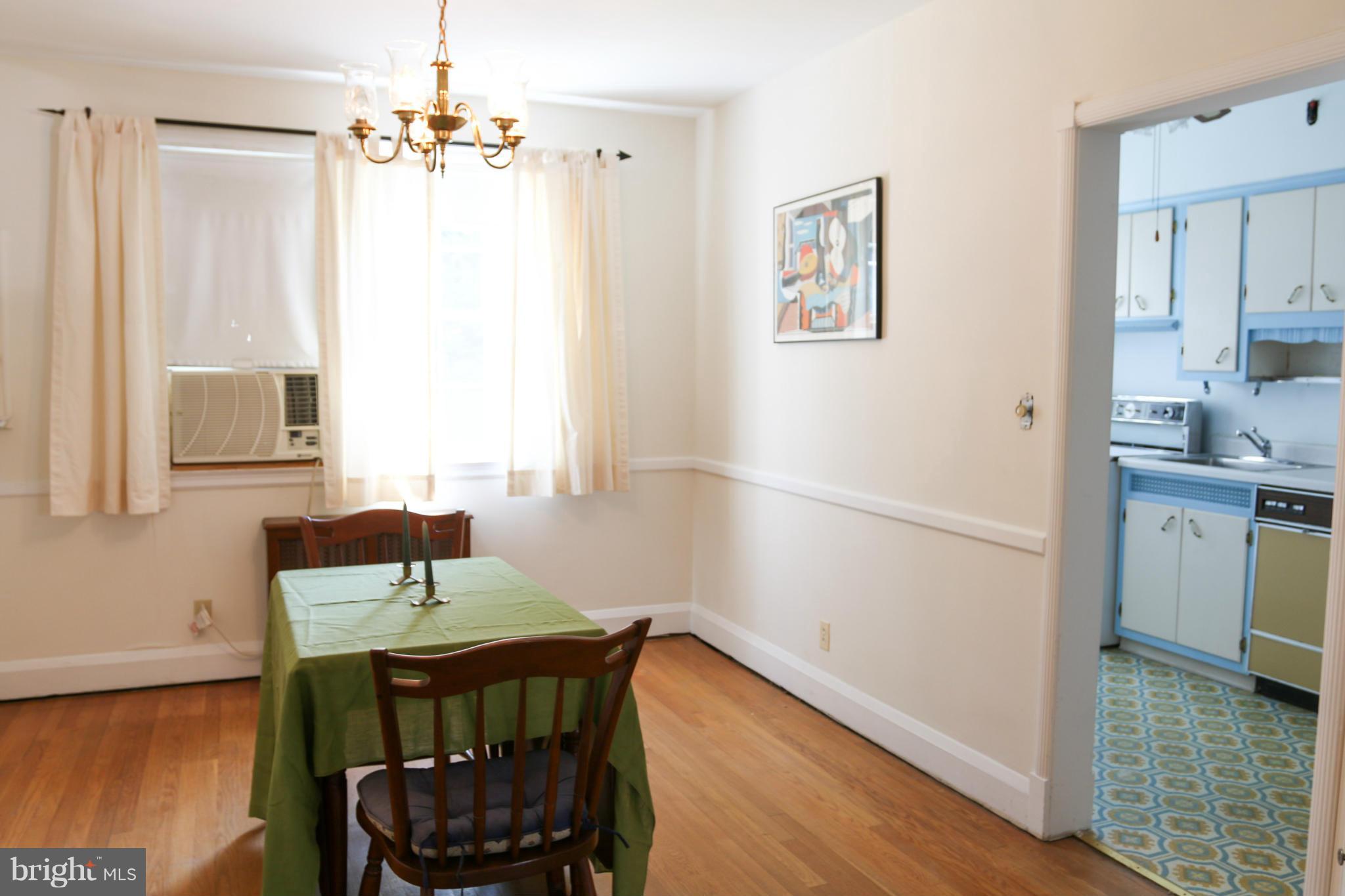 309 Westowne Road Baltimore, MD 21229 - Photo 5 of 20 a bedroom with a bed and a table in it