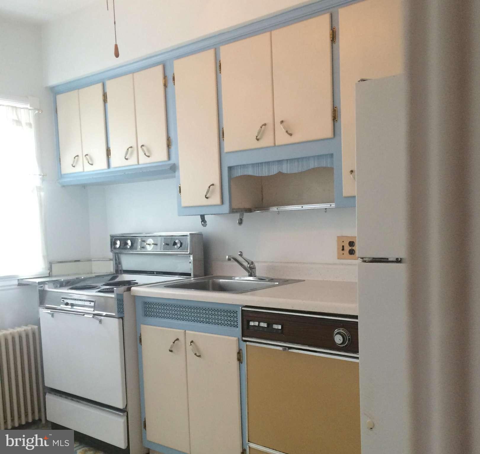 309 Westowne Road Baltimore, MD 21229 - Photo 7 of 20 a kitchen with stainless steel appliances granite countertop a sink a stove and white cabinets