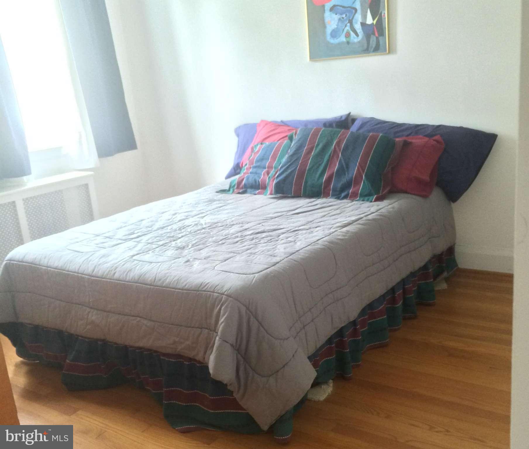 309 Westowne Road Baltimore, MD 21229 - Photo 9 of 20 a bedroom with a bed and wooden floor