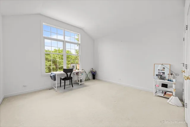 a spacious bedroom with a bed and a large window