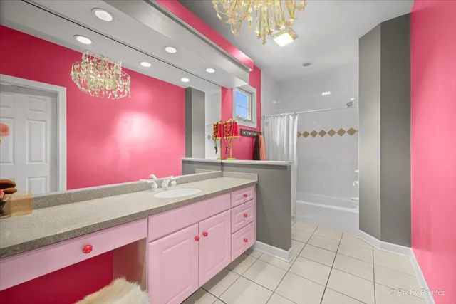 a bedroom with furniture a large window and a chandelier