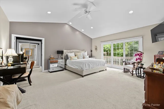 a bedroom with a bed a chandelier and dresser