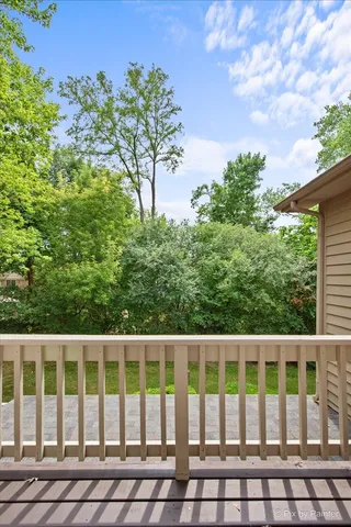 a large kitchen with stainless steel appliances wooden cabinets and a large window
