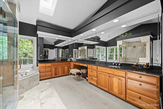 a large white kitchen with a large window