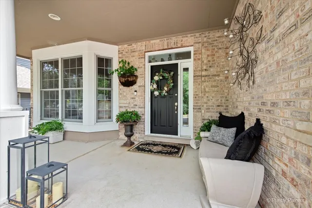 a building outdoor space with patio furniture and potted plants
