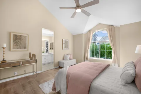 a bedroom with a large bed and a window