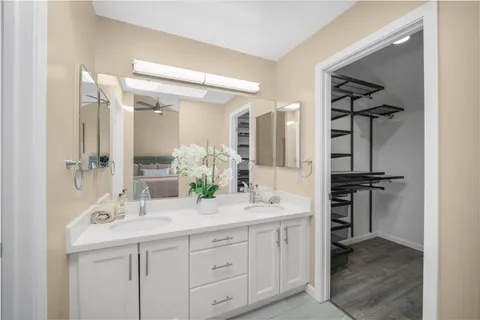 a bathroom with a double vanity sink and a mirror