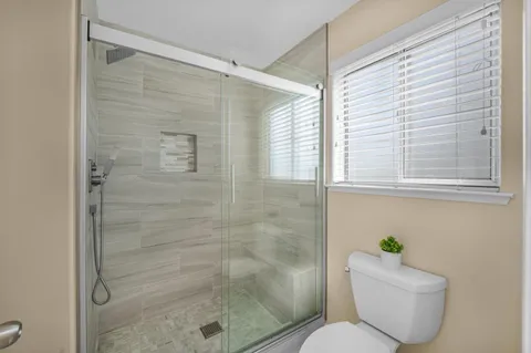 a bathroom with a toilet and shower