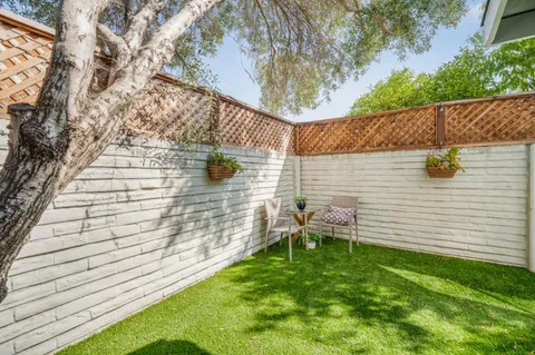 a view of a backyard with chairs