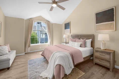 a bedroom with a bed and glass window