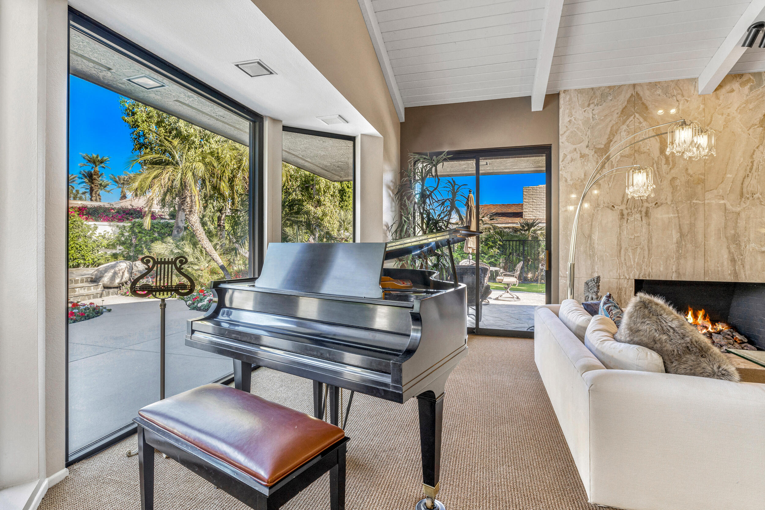15 Johnar Boulevard Rancho Mirage, CA 92270 - Photo 20 of 68 a living room with furniture a lamp and a potted plant