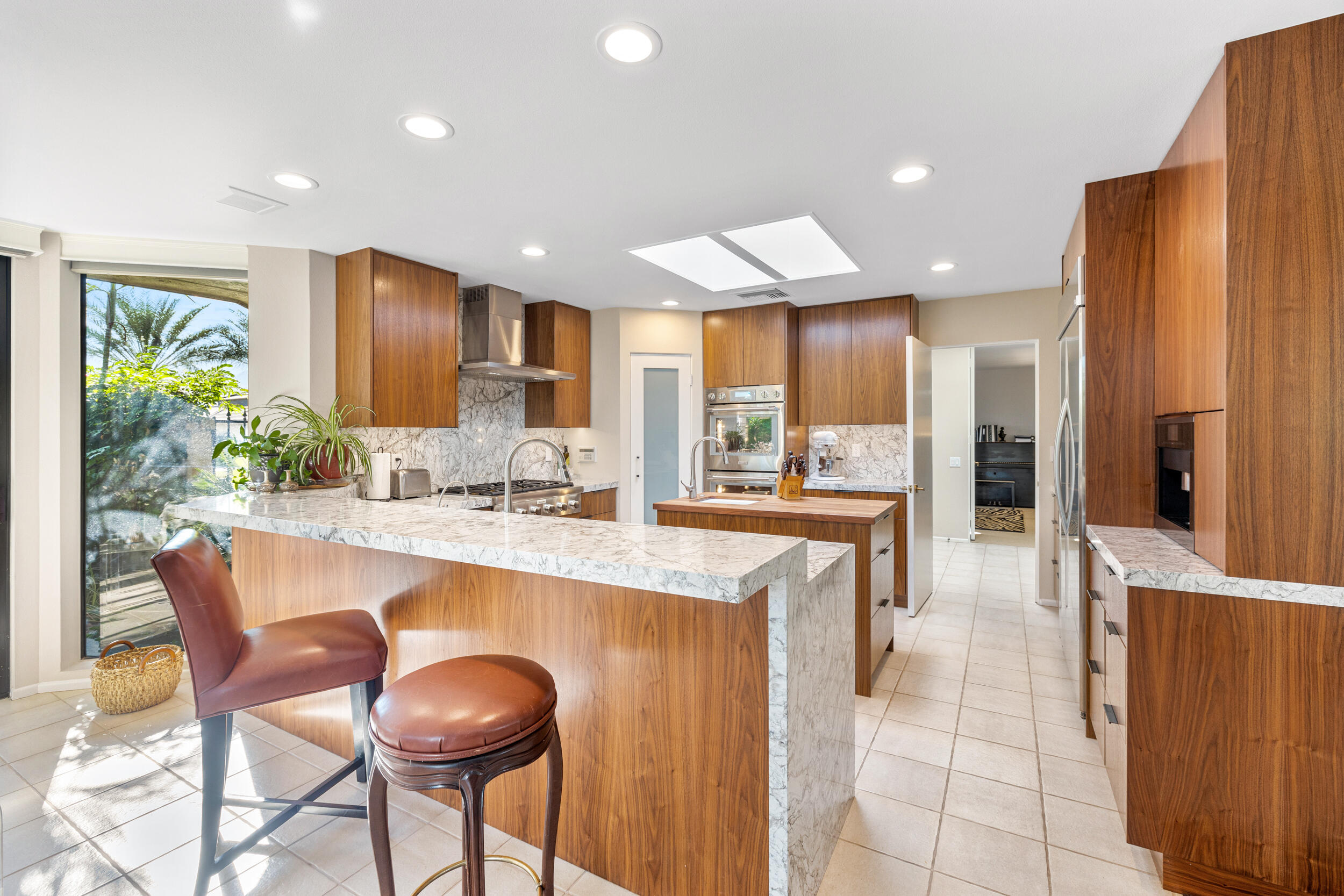 15 Johnar Boulevard Rancho Mirage, CA 92270 - Photo 22 of 68 a kitchen with stainless steel appliances granite countertop a refrigerator and a stove top oven