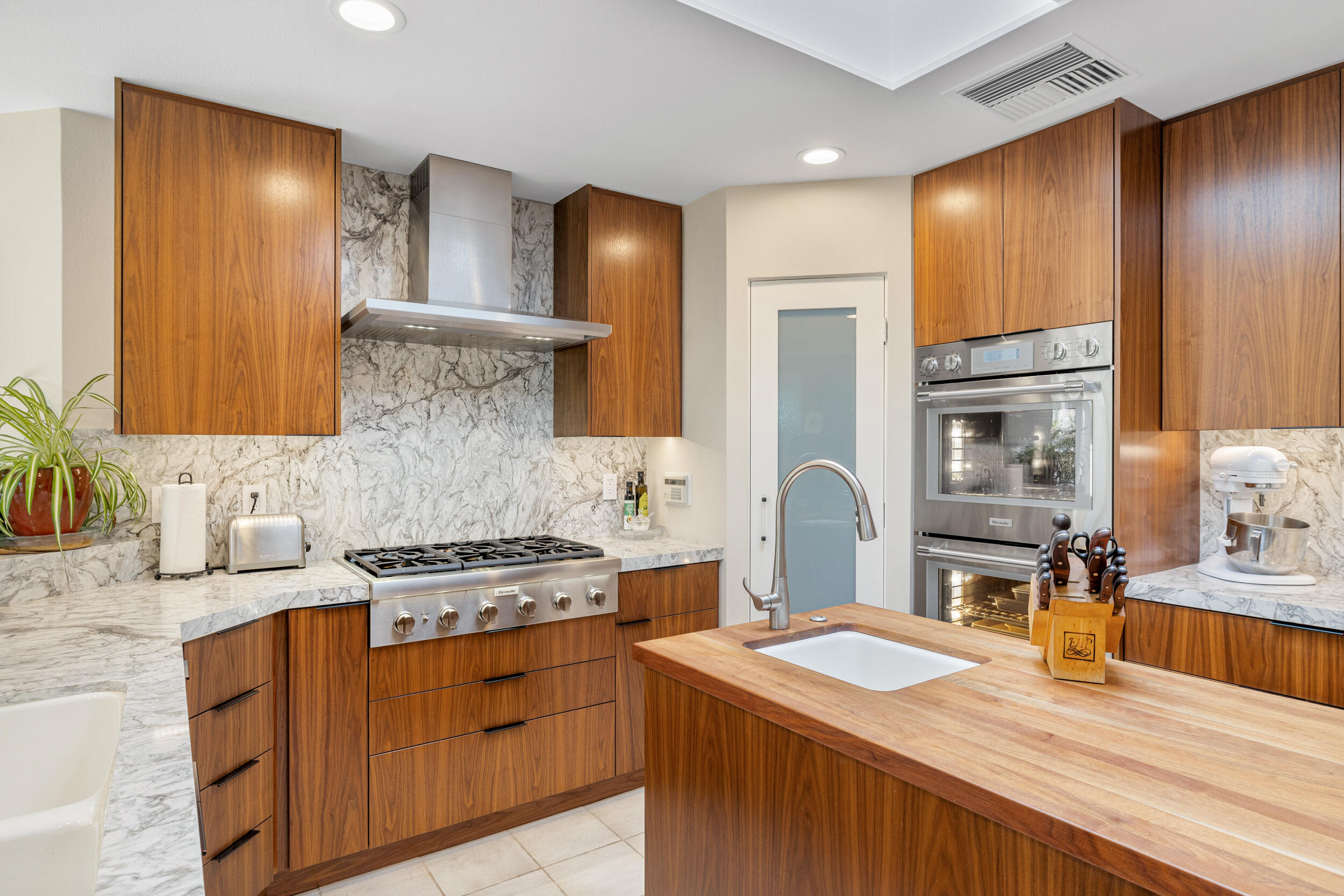 15 Johnar Boulevard Rancho Mirage, CA 92270 - Photo 23 of 68 a kitchen with stainless steel appliances granite countertop a sink stove and refrigerator