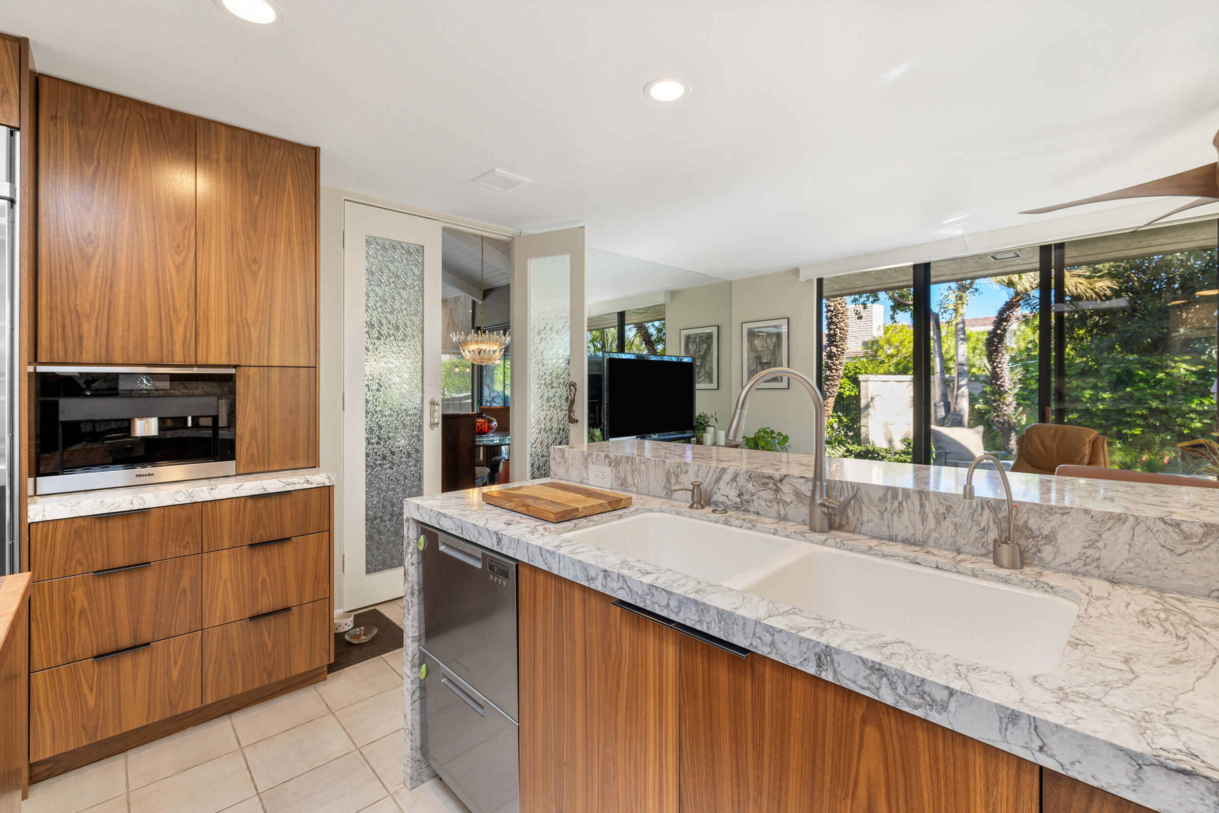 15 Johnar Boulevard Rancho Mirage, CA 92270 - Photo 26 of 68 a kitchen with granite countertop sink and cabinets