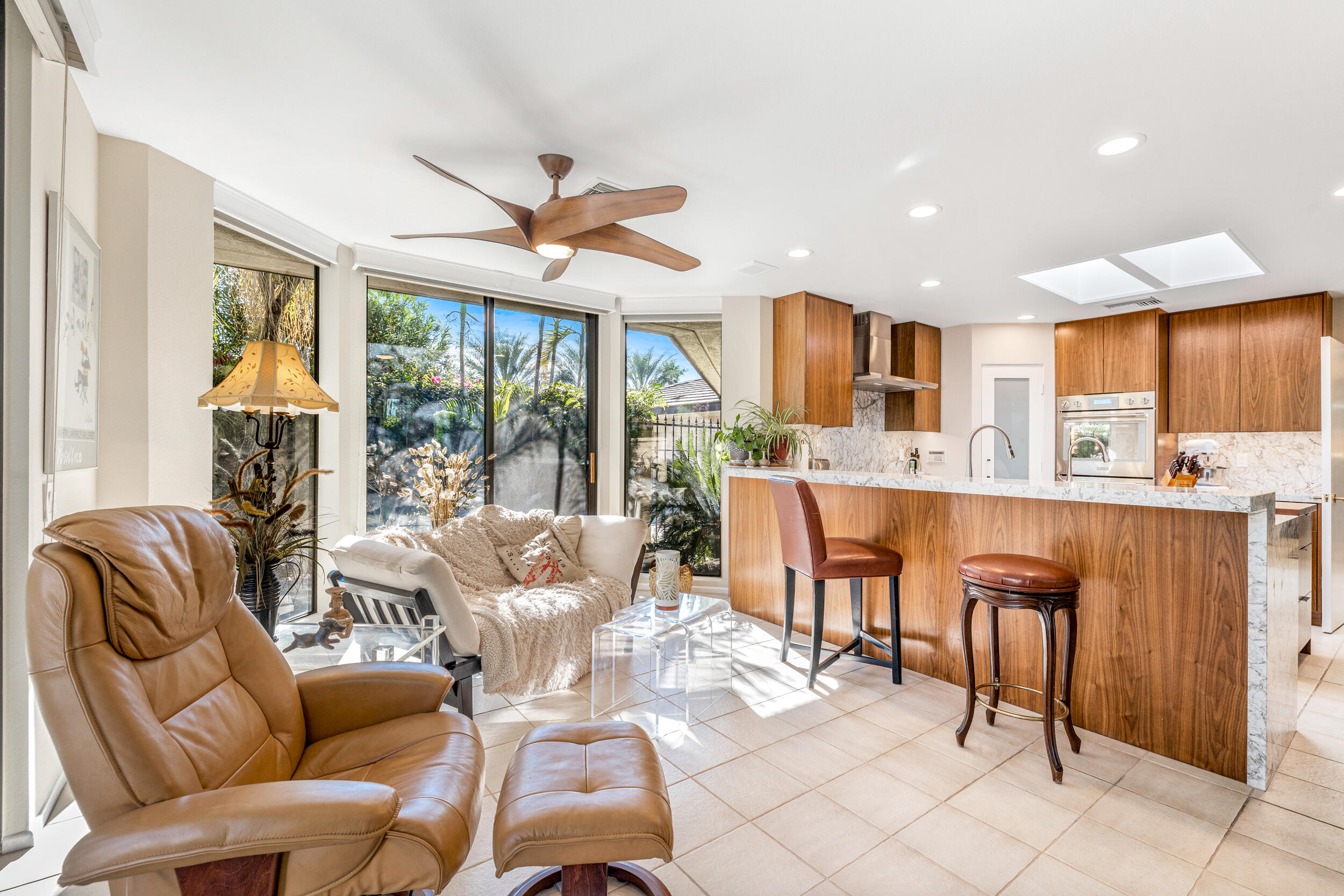 15 Johnar Boulevard Rancho Mirage, CA 92270 - Photo 28 of 68 a living room with stainless steel appliances kitchen island granite countertop furniture and a large window