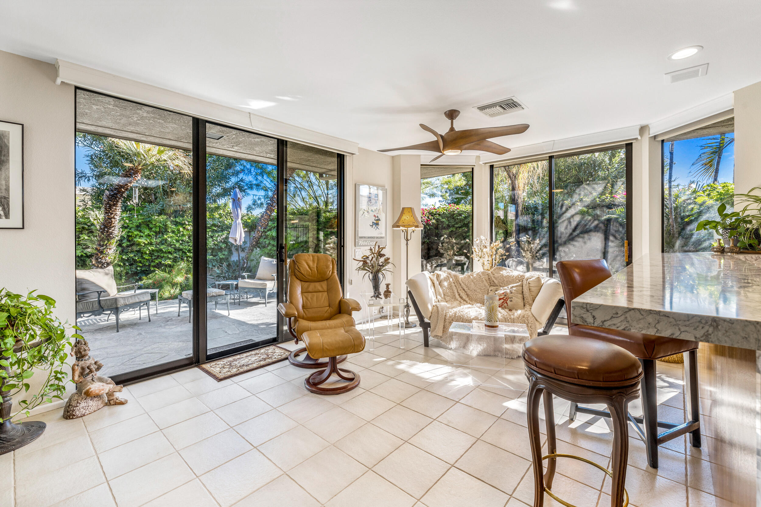 15 Johnar Boulevard Rancho Mirage, CA 92270 - Photo 31 of 68 a living room with furniture a flat screen tv and a large window