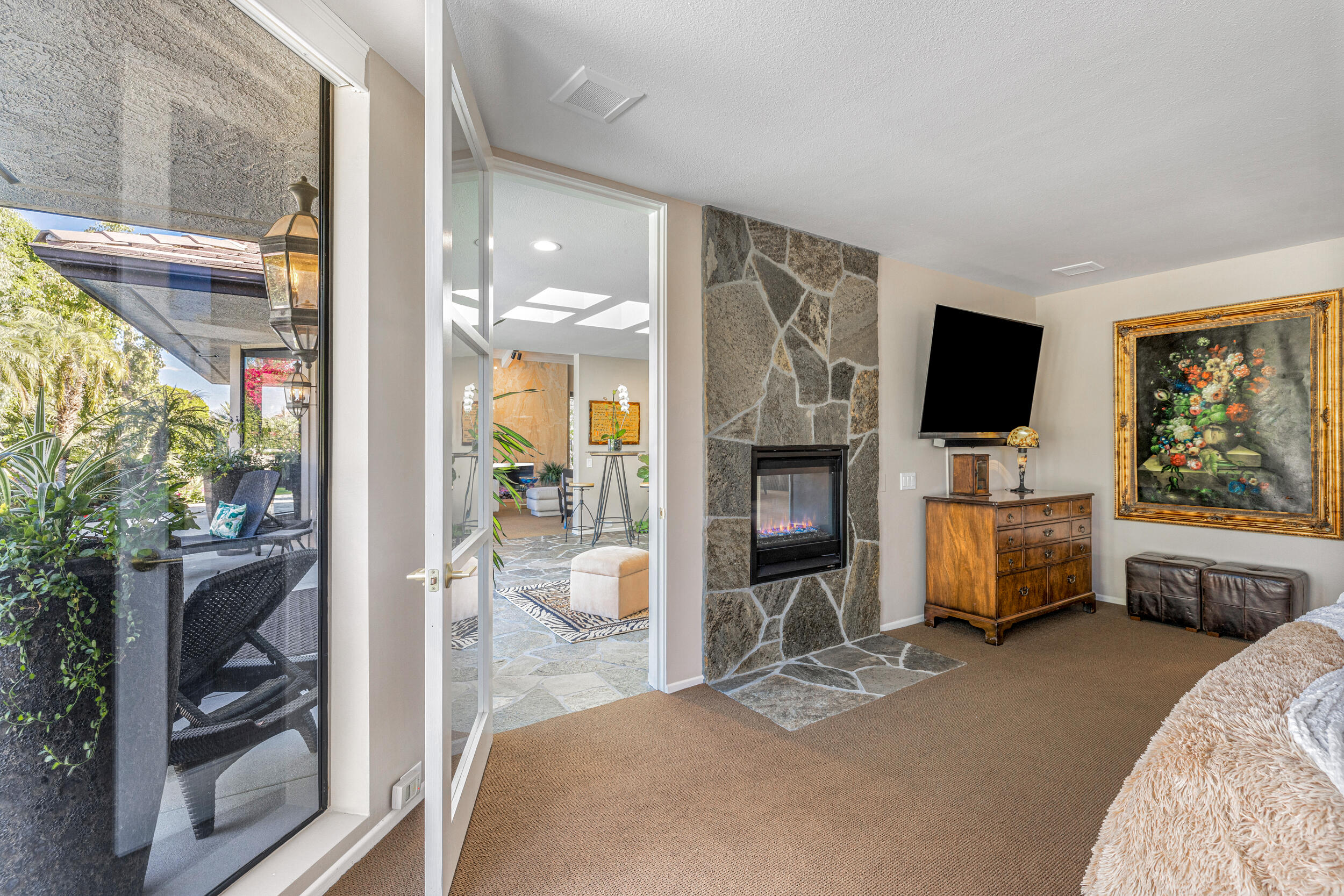 15 Johnar Boulevard Rancho Mirage, CA 92270 - Photo 33 of 68 a bedroom with furniture a flat screen tv and a fireplace