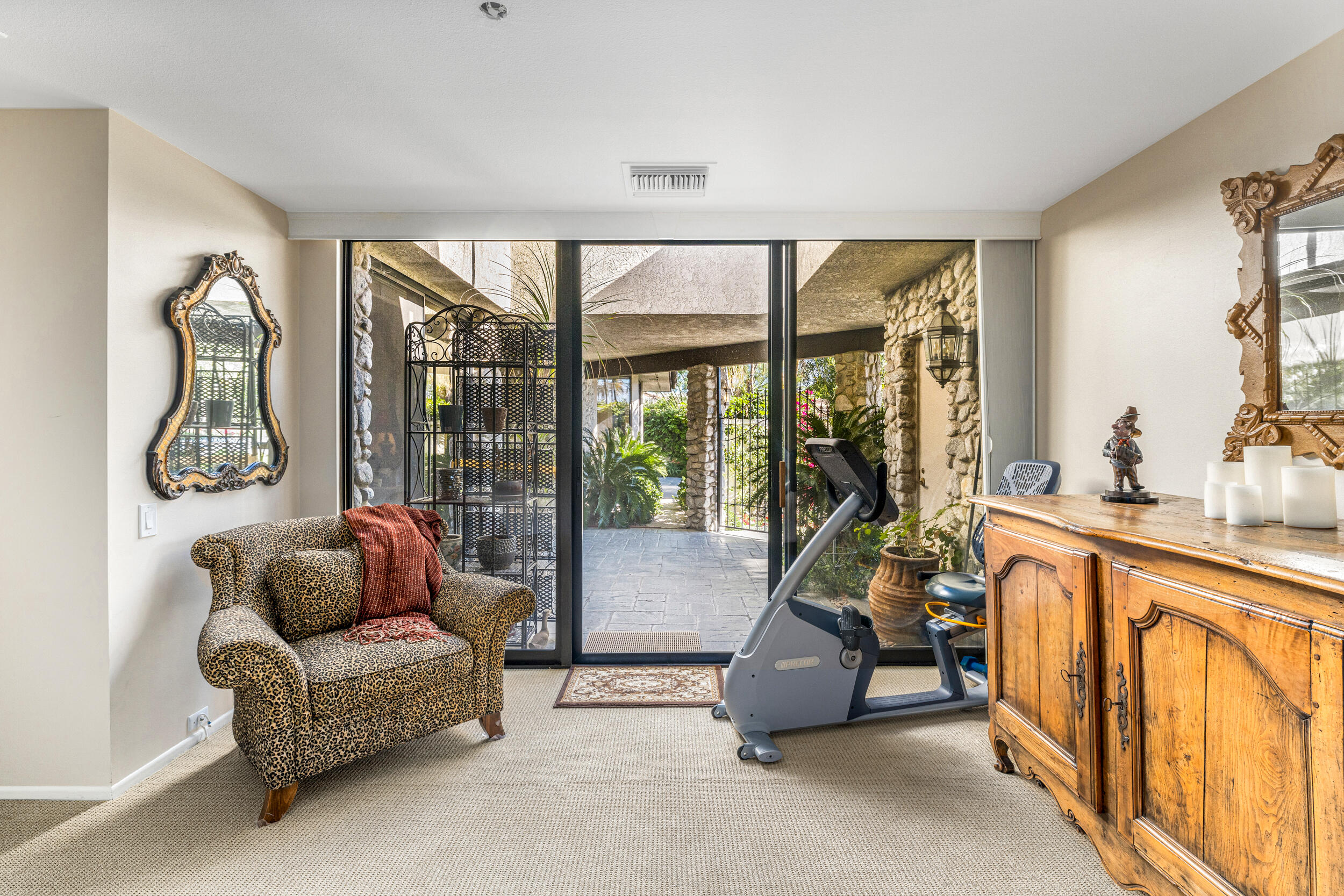 15 Johnar Boulevard Rancho Mirage, CA 92270 - Photo 37 of 68 a living room with furniture a floor to ceiling window and a flat screen tv