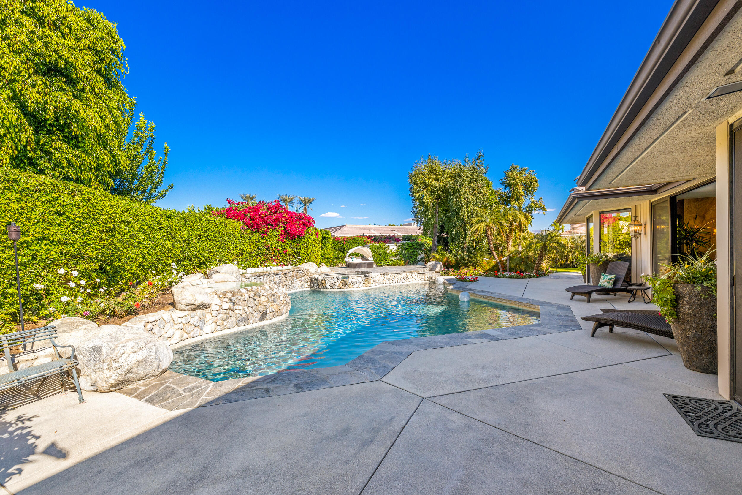 15 Johnar Boulevard Rancho Mirage, CA 92270 - Photo 43 of 68 a view of a patio with couches and potted plants