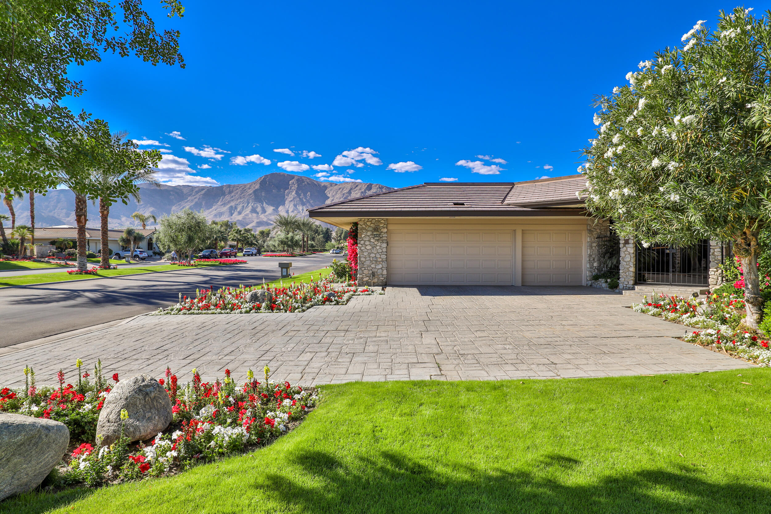 15 Johnar Boulevard Rancho Mirage, CA 92270 - Photo 5 of 68 a front view of a house with a yard and a garage
