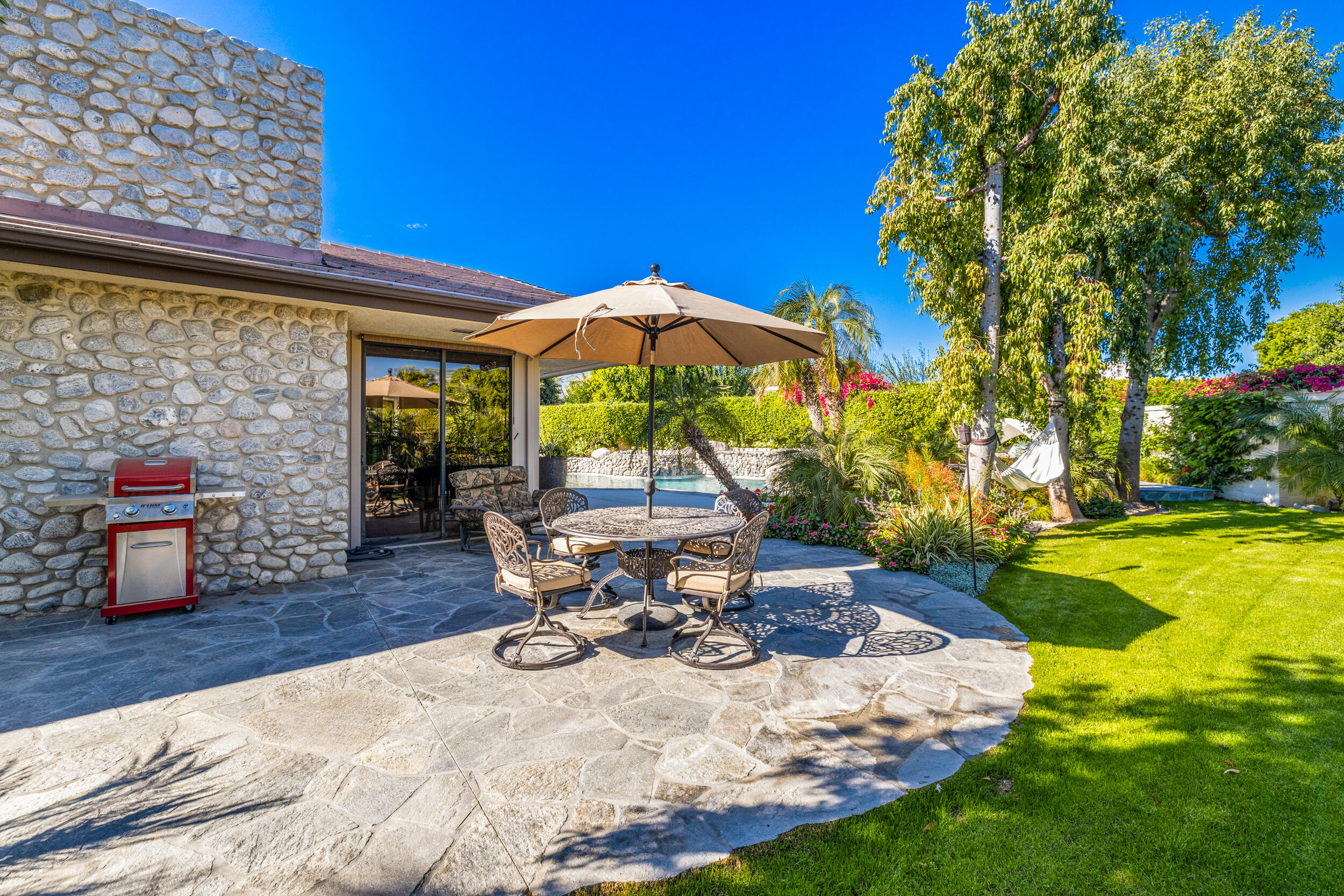 15 Johnar Boulevard Rancho Mirage, CA 92270 - Photo 53 of 68 a view of a swimming pool with chairs in patio