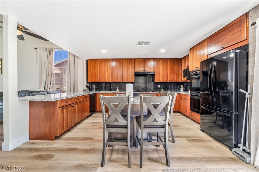 104 Appian Way Henderson, NV 89002 - Photo 10 of 24 A gourmet kitchen boasts generous counter space and richly toned cabinetry, perfect for culinary adventures.