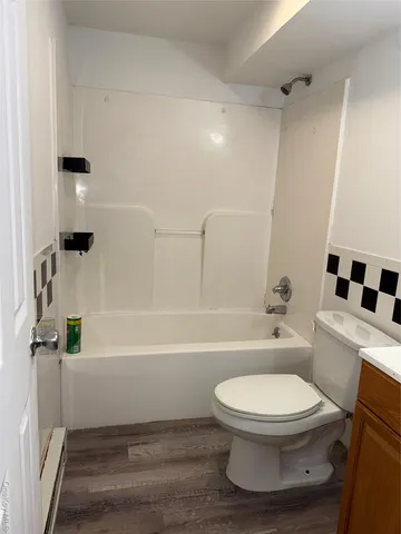 a bathroom with a toilet and a bath tub