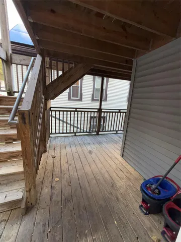 a view of deck with wooden floor and a barbeque