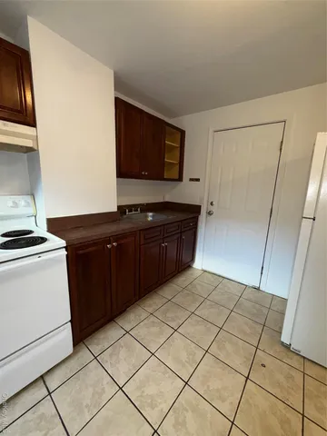 a kitchen with a sink and a stove top oven