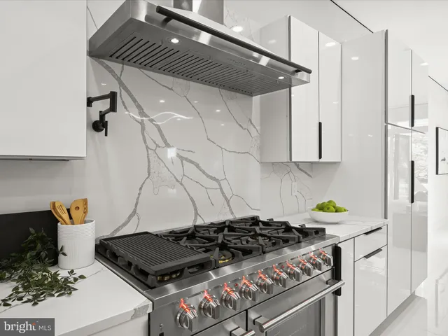 a living room with furniture a large window and kitchen view