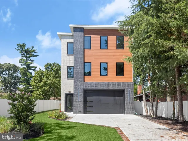 a front view of a house with a garden and yard
