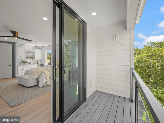 an aerial view of residential houses with outdoor space and trees
