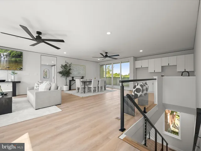 a lake view with a bench and trees in the background