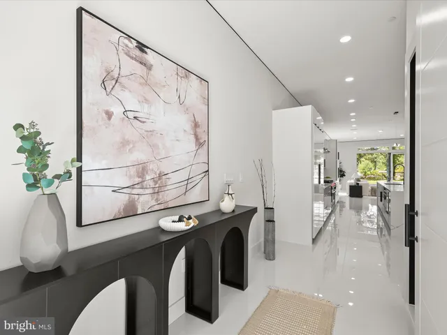 a large white kitchen with a large window