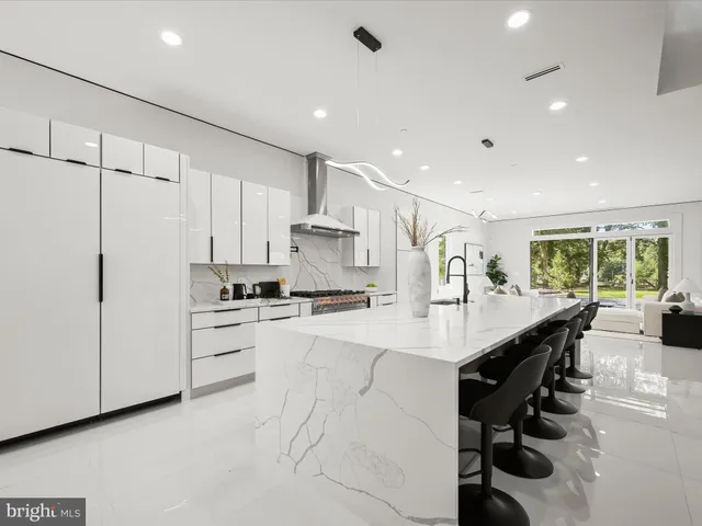 a kitchen with sink stove and refrigerator