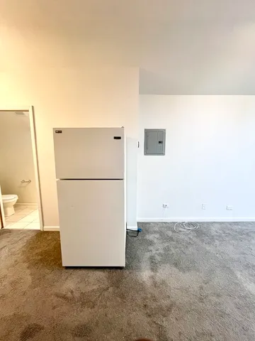 a view of a refrigerator in a kitchen