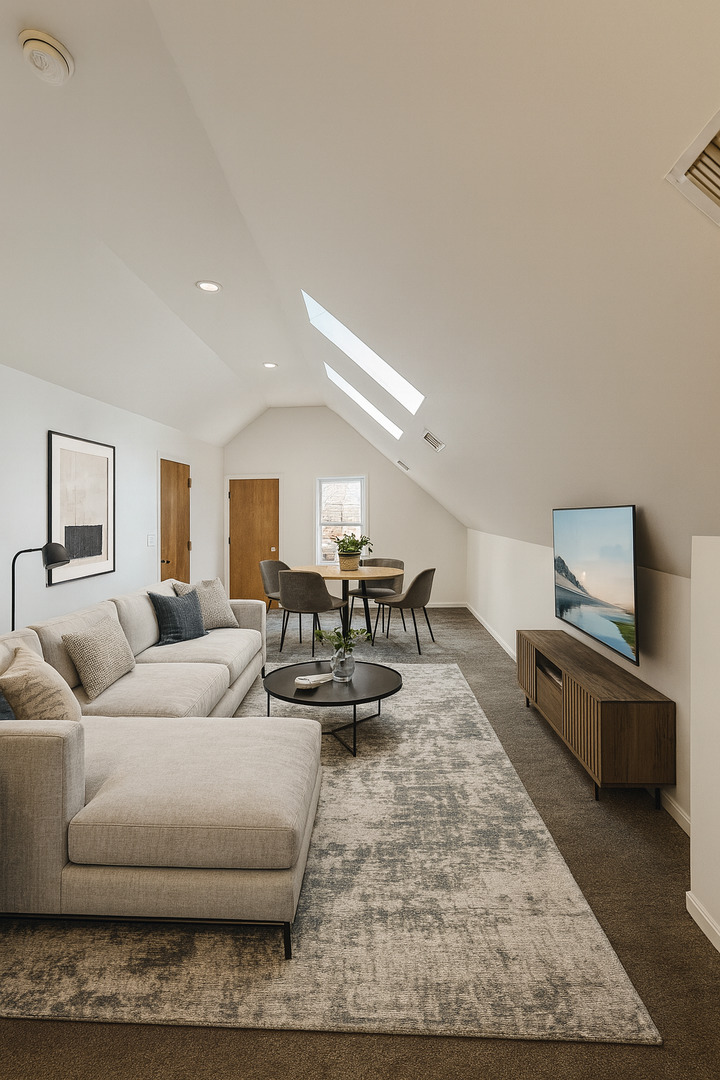 3227 South Carpenter Street, Unit 4F Chicago, IL 60608 - Photo 2 of 12 a living room with furniture and a flat screen tv