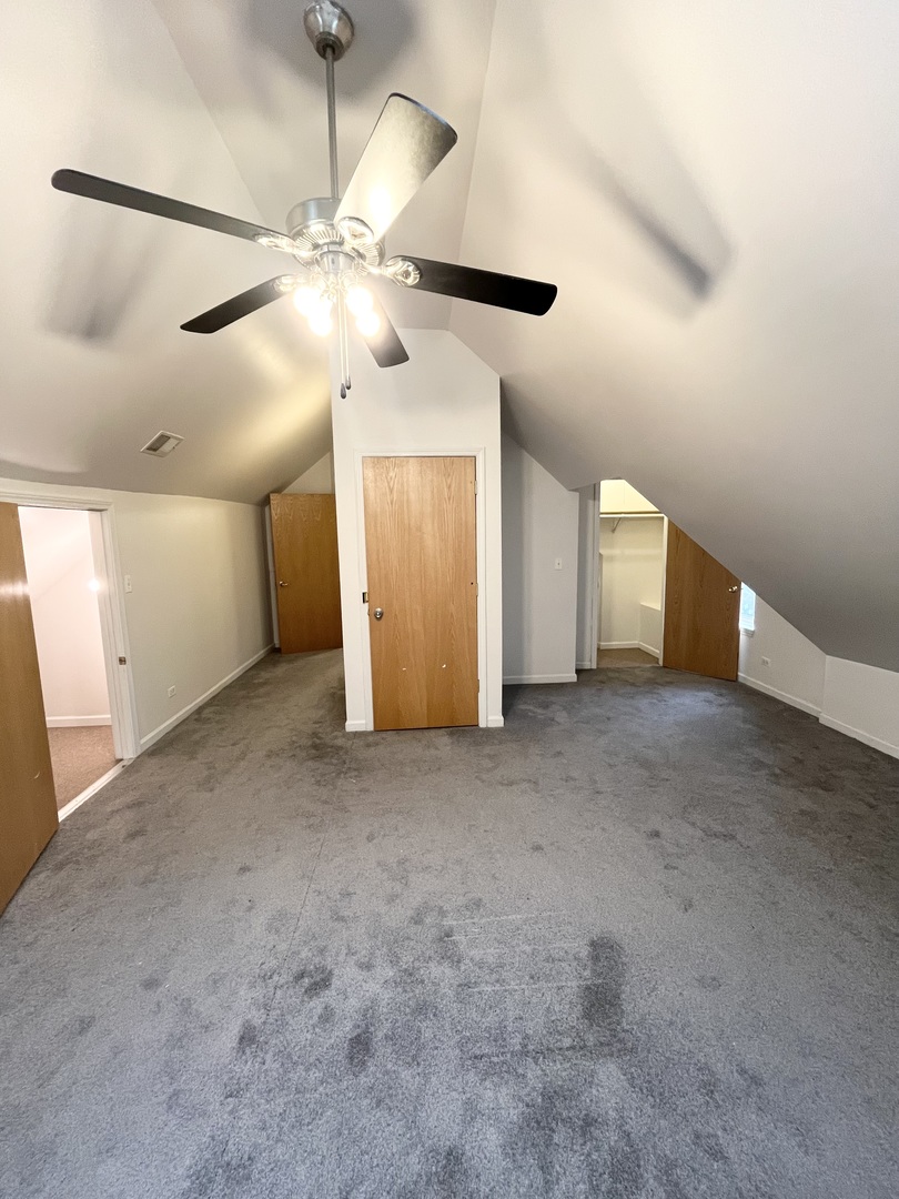 3227 South Carpenter Street, Unit 4F Chicago, IL 60608 - Photo 3 of 12 a view of a big room with a ceiling fan and entryway