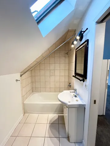 a bathroom with a sink a mirror and a bathtub