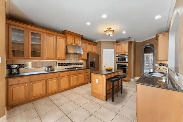 a kitchen with stainless steel appliances granite countertop a sink and cabinets